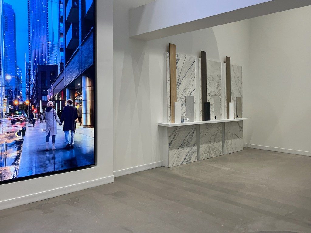 Commercial Sales Office Interior with marble display panels overlooking a city street, project by colorlab.